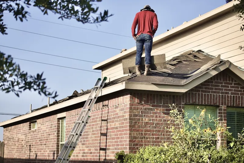 Professional roofer working on a residential roof in Waterman